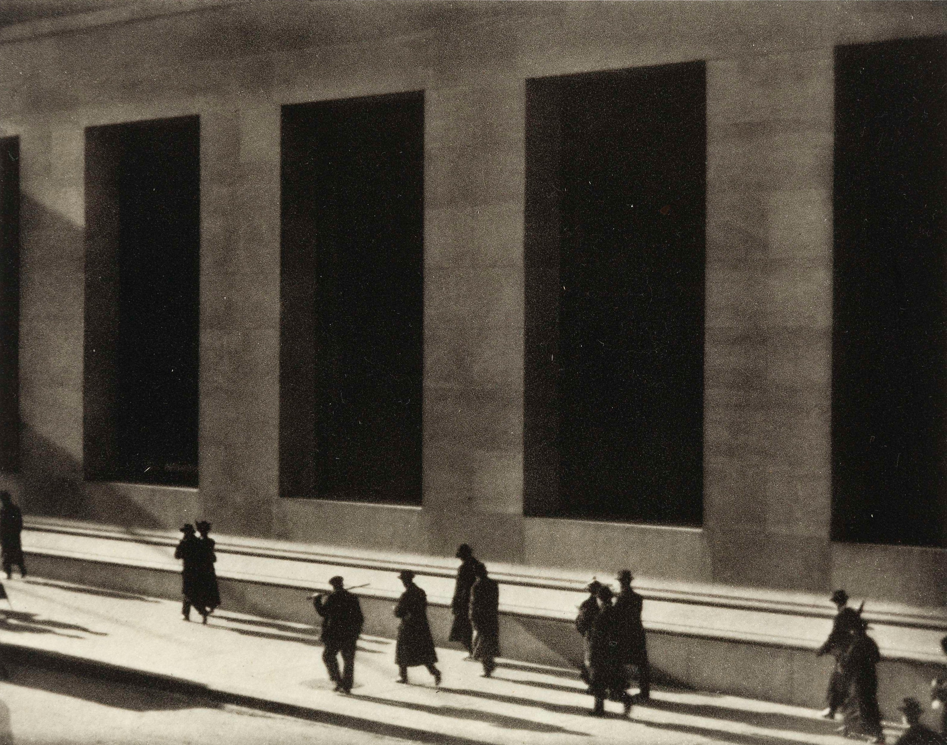 Paul Strand, Wall Street, 1915 — tiny human figures passing the dark windows of the JP Morgan bank building
