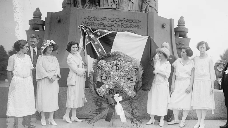 United Daughters of the Confederacy members at a monument dedication ceremony, women in period dress surrounding a Confederate memorial